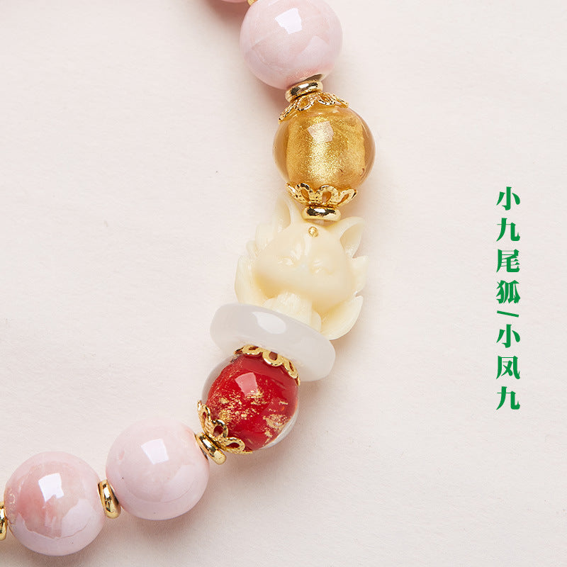Yongxiang with Beijing ash glazed hand string / powder porcelain nine-tailed fox gold leaf good luck bracelet / girlfriend gift